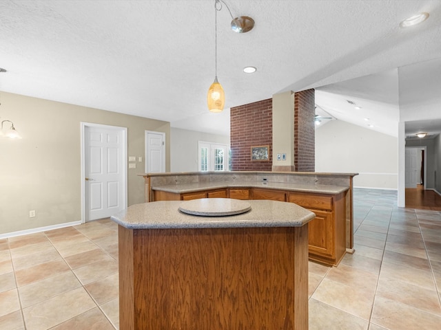 kitchen featuring lofted ceiling, light tile patterned floors, a kitchen island, and decorative light fixtures