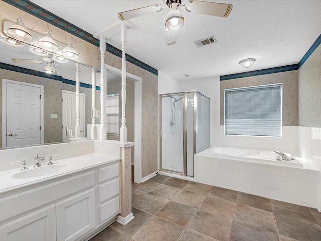 bathroom featuring plus walk in shower, a textured ceiling, vanity, and tile patterned floors