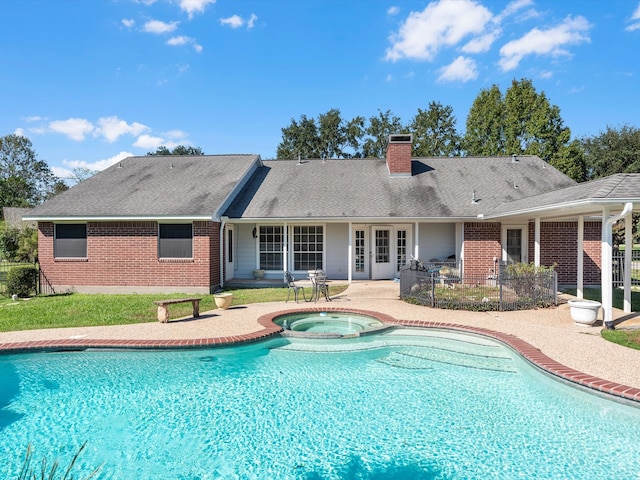 view of pool with an in ground hot tub and a patio