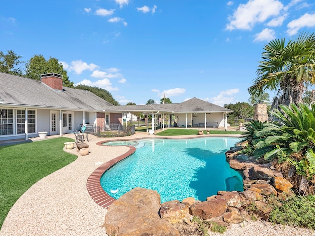 view of swimming pool featuring a patio area, an in ground hot tub, and a yard