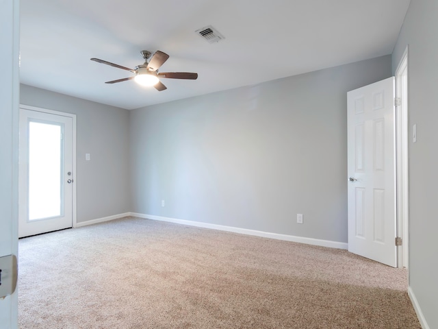 carpeted spare room with ceiling fan