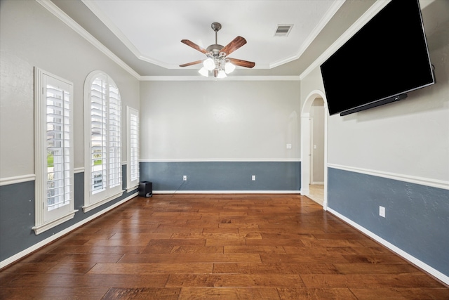 spare room with ceiling fan, crown molding, and dark wood-type flooring