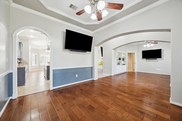 unfurnished living room with hardwood / wood-style floors and ornamental molding