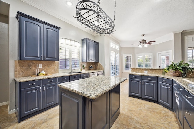 kitchen featuring decorative backsplash, light stone countertops, a textured ceiling, sink, and a kitchen island