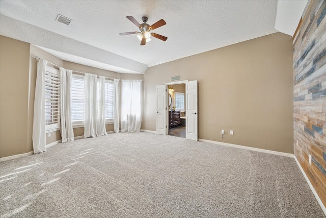 unfurnished bedroom with ceiling fan, carpet, and a textured ceiling