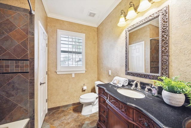 bathroom with tiled shower, vanity, toilet, and crown molding