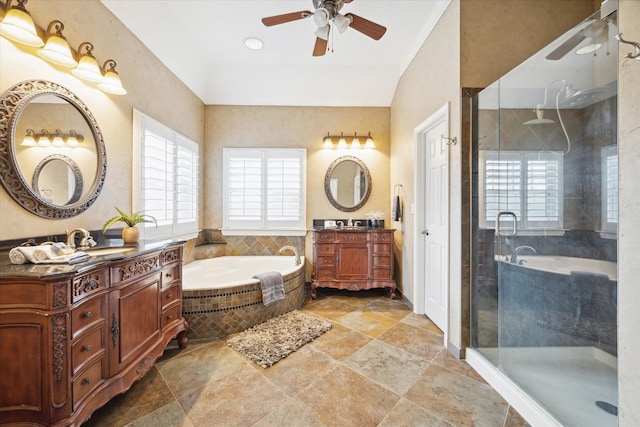 bathroom featuring ceiling fan, vanity, and independent shower and bath