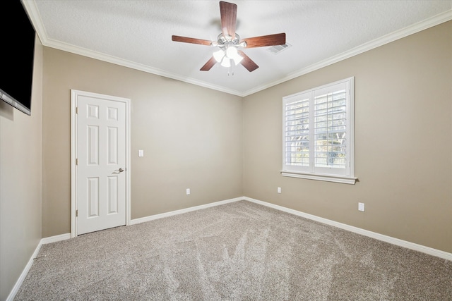 carpeted spare room with ceiling fan, ornamental molding, and a textured ceiling