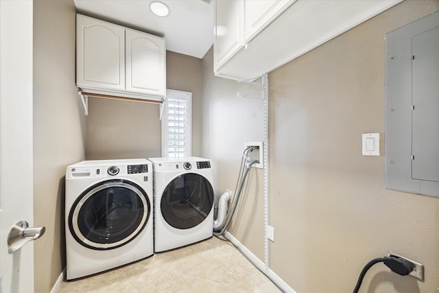 laundry room featuring electric panel, cabinets, light tile patterned floors, and washing machine and dryer