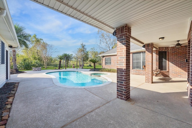 view of swimming pool featuring an in ground hot tub, a patio, and ceiling fan