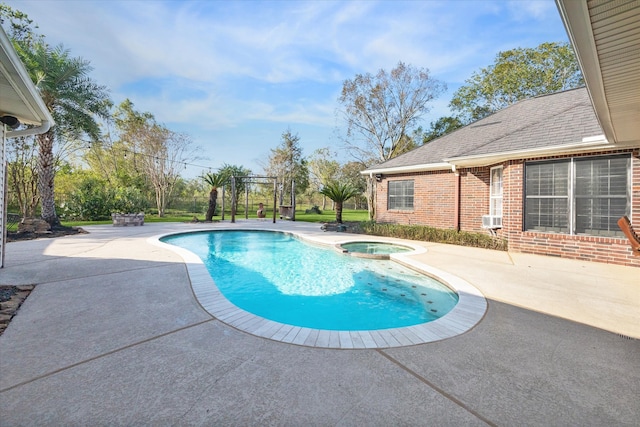 view of pool featuring a patio area, an in ground hot tub, and cooling unit