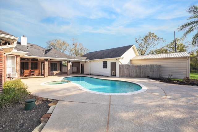 view of swimming pool featuring an in ground hot tub and a patio