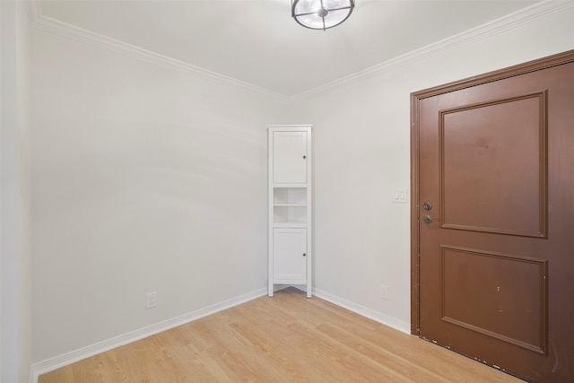 empty room with light hardwood / wood-style flooring and ornamental molding