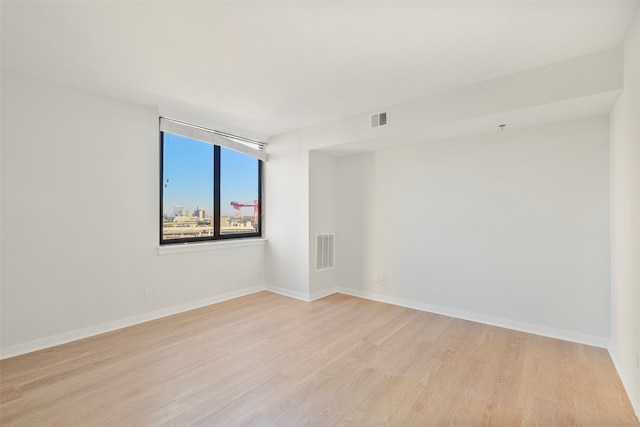 spare room with light hardwood / wood-style floors