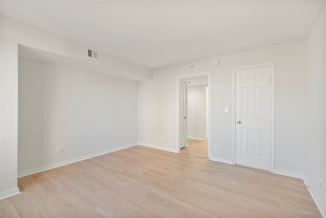 spare room with light hardwood / wood-style floors