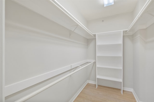 spacious closet with light hardwood / wood-style floors