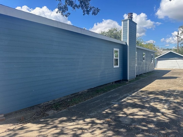 view of home's exterior featuring a garage and an outdoor structure