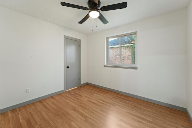 unfurnished room with ceiling fan and light wood-type flooring