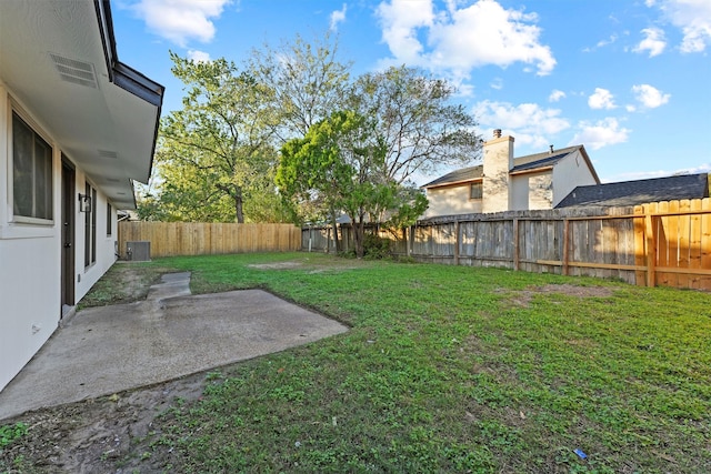 view of yard featuring cooling unit and a patio