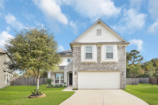 view of front of house with a garage and a front lawn