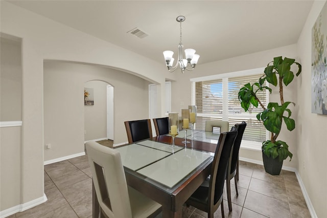 dining area featuring a chandelier and light tile patterned flooring