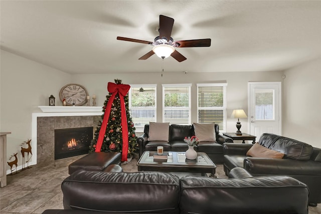 living room with ceiling fan, light tile patterned floors, a fireplace, and a wealth of natural light