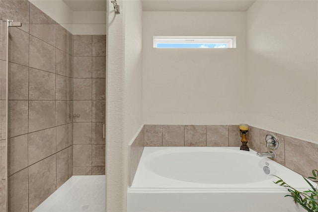 bathroom with separate shower and tub