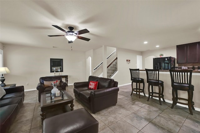 living room featuring ceiling fan and light tile patterned flooring