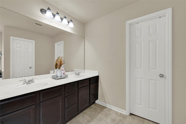 bathroom with tile patterned flooring and vanity