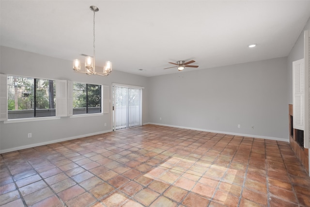 unfurnished room featuring ceiling fan with notable chandelier