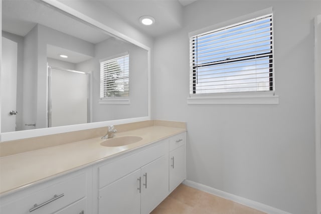 bathroom with tile patterned floors, vanity, and an enclosed shower