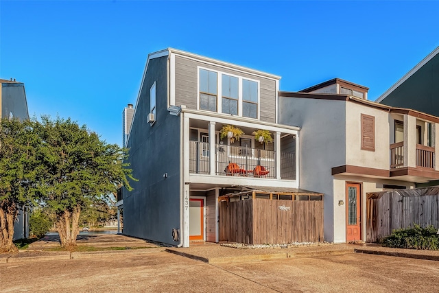 exterior space with fence and stucco siding