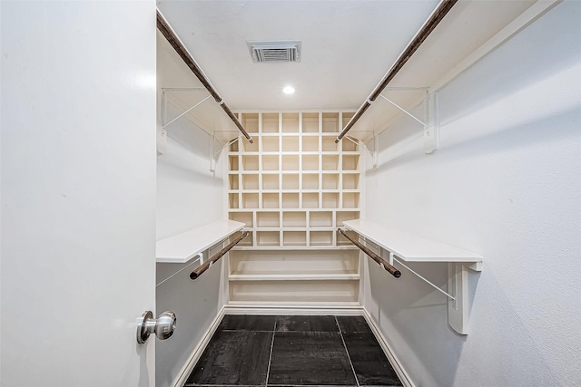 spacious closet featuring visible vents and wood finished floors