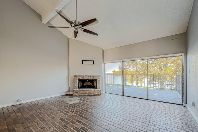 unfurnished living room featuring a brick fireplace, baseboards, ceiling fan, brick floor, and high vaulted ceiling