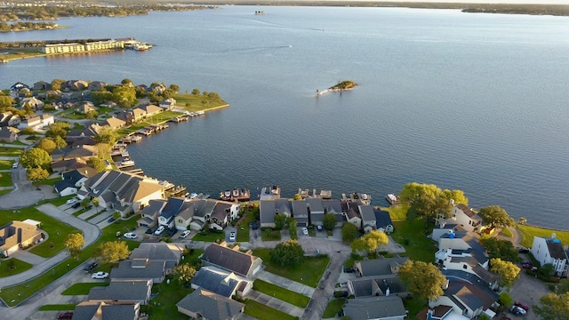 drone / aerial view with a water view and a residential view