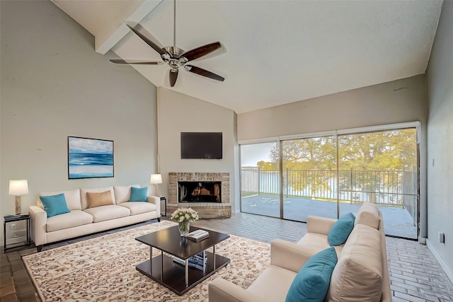 living room with beam ceiling, ceiling fan, high vaulted ceiling, and a brick fireplace