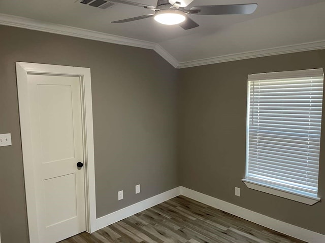 spare room featuring wood-type flooring, vaulted ceiling, ceiling fan, and crown molding