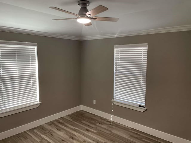 spare room with crown molding, ceiling fan, and wood-type flooring