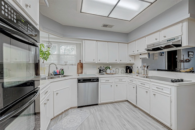 kitchen featuring black appliances, white cabinets, sink, and light hardwood / wood-style flooring