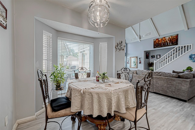 dining area featuring vaulted ceiling with beams and light hardwood / wood-style floors