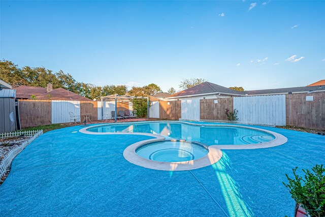 view of swimming pool featuring an in ground hot tub