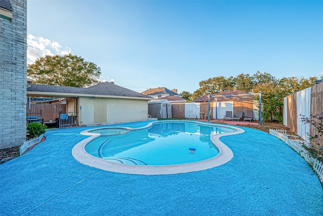 view of swimming pool with a storage shed