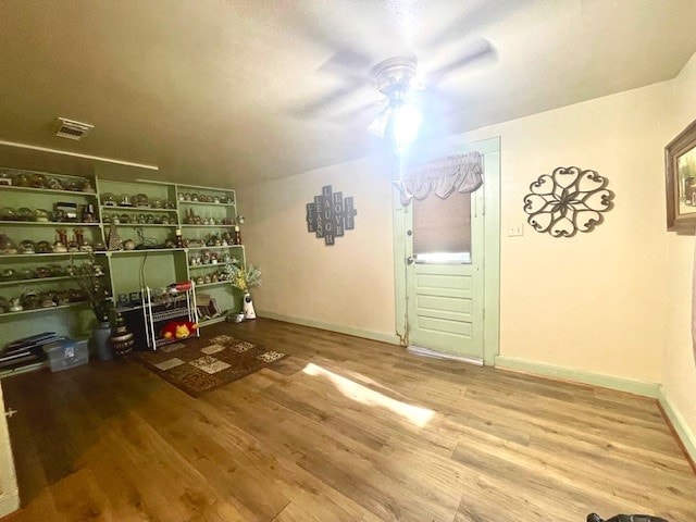 interior space with ceiling fan and wood-type flooring