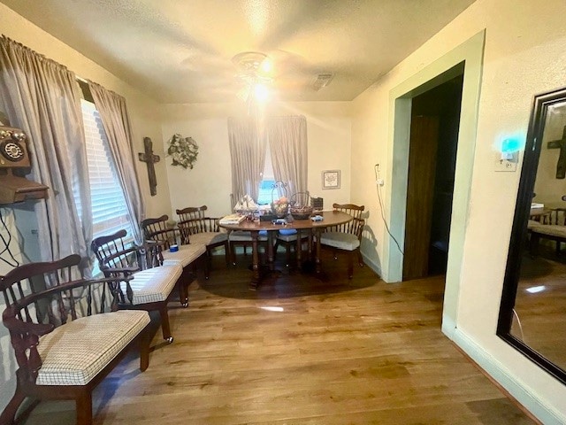 dining space featuring ceiling fan and light hardwood / wood-style floors