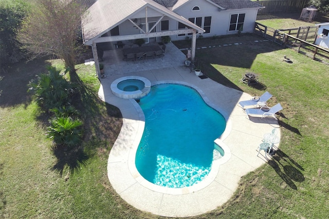 view of swimming pool with an in ground hot tub, a patio area, a fire pit, and a lawn