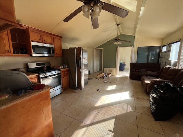 kitchen with lofted ceiling with beams, ceiling fan, light tile patterned floors, and appliances with stainless steel finishes