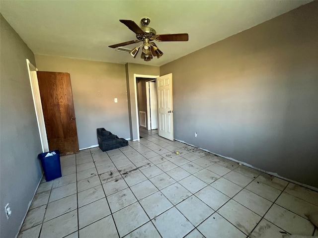 unfurnished bedroom featuring ceiling fan and light tile patterned floors