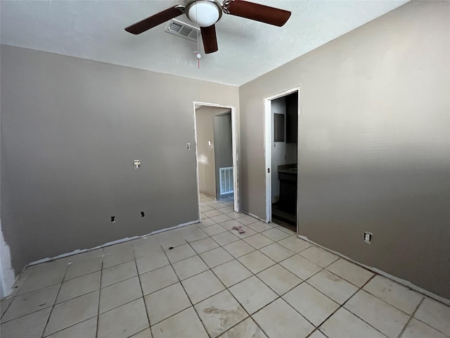 unfurnished room with ceiling fan and light tile patterned flooring