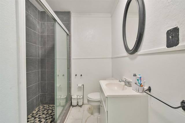 bathroom with vanity, toilet, an enclosed shower, and crown molding