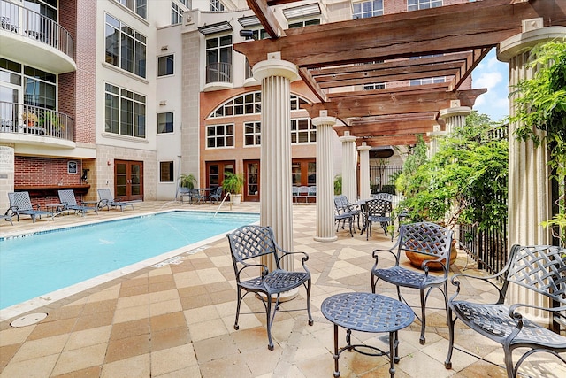 view of swimming pool featuring a pergola and a patio